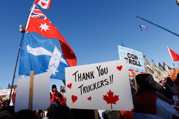 Supporters of the convoy of truckers protesting coronavirus vaccine mandates and pandemic restrictions rally around Parliament Hill in downtown Ottawa on Saturday, Jan, 29, 2022. (Nasuna Stuart-Ulin/The New York Times)