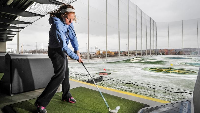 Taylor Jones, from New Carlisle, plays a round at TopGolf as the snow falls Thursday, Jan. 5, in West Chester Twp. TopGolf is an all-season golf entertainment complex with complete bar and restaurant services and heated tees. NICK GRAHAM/STAFF