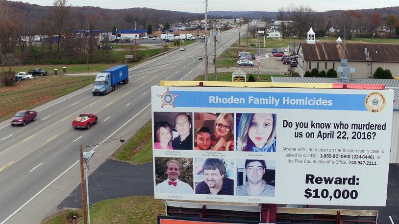 The reward billboard remains after arrests have been made in the Rhoden family slaying case that happened 2½ years ago, putting Pike County residents on edge. TY GREENLEES / STAFF