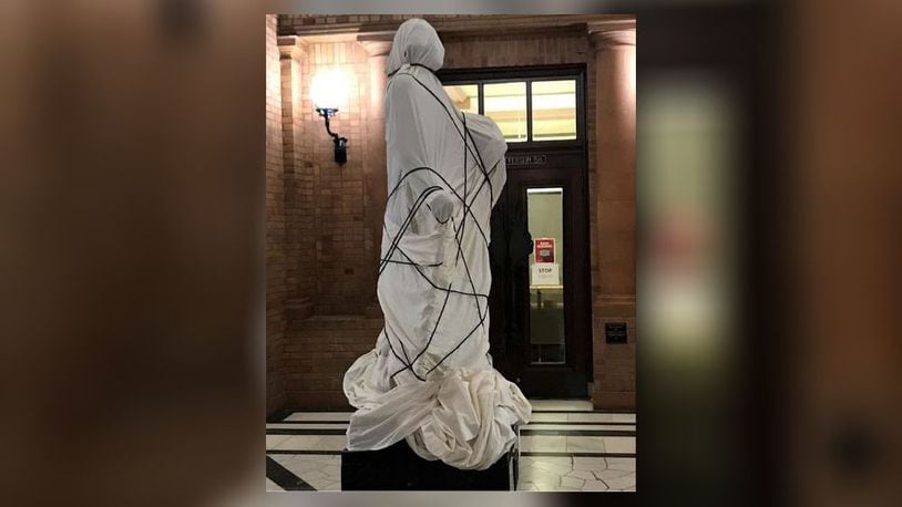 A statue of George Washington on Miami University’s campus was covered with a tarp as part of a class project about racism in the fall of 2020. CONTRIBUTED