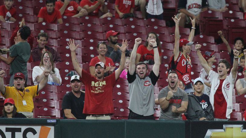 Reds fans cheer after a strikeout against the Angels on Tuesday, Aug. 6, 2019, at Great American Ball Park in Cincinnati. David Jablonski/Staff