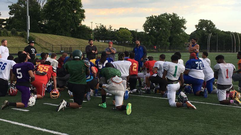 The West’s players and coaches have a post-practice meeting Tuesday at Woodward High School. RICK CASSANO/STAFF