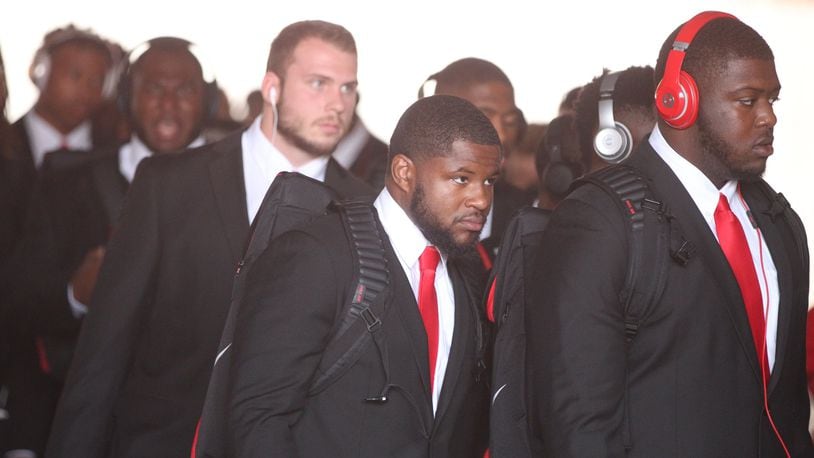 Ohio State players, including Mike Weber, center, arrive at Memorial Stadium before a game against Indiana on Thursday, Aug. 31, 2017, in Bloomington, Ind. David Jablonski/Staff