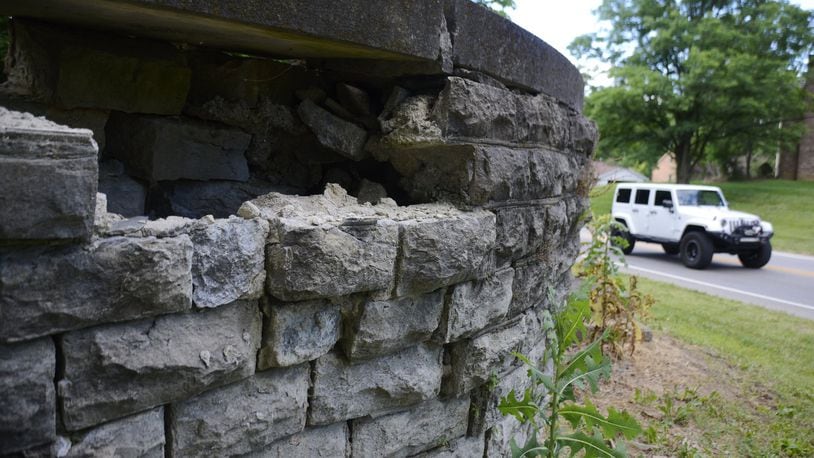 The remains of an old perimeter wall from the early 1900s have fallen in greater disrepair in the past few years. The 860-foot structure is bulging in some areas and have been completely comprised in other areas. The wall spans the rear of eight properties from Hunter Road to the south end of the Emerald Lake subdivision. Pictured is a compromised section of the wall on June 25, 2020, just south of the Emerald Lake subdivision. MICHAEL D. PITMAN/STAFF