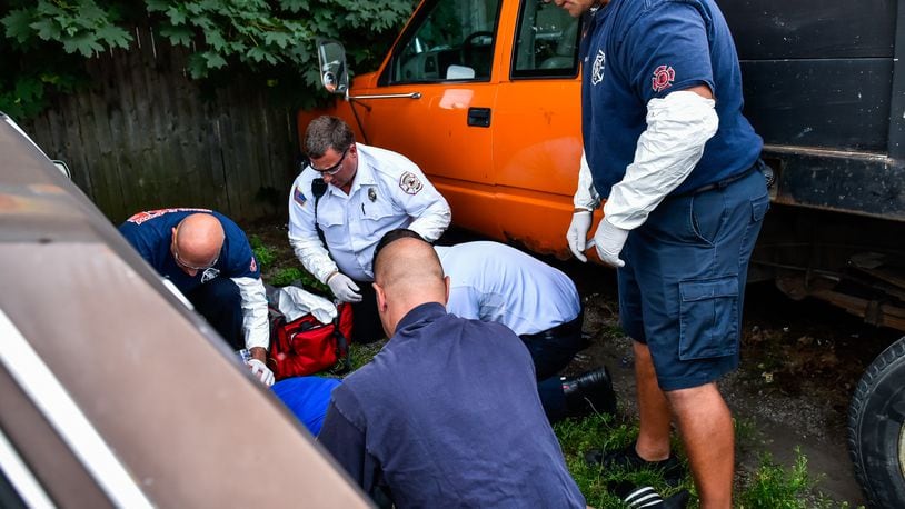 Middletown paramedics and police officers responded to a drug overdose behind the Midd-Town Carry Out on Central Avenue on Monday, June 26 in Middletown. NICK GRAHAM/STAFF