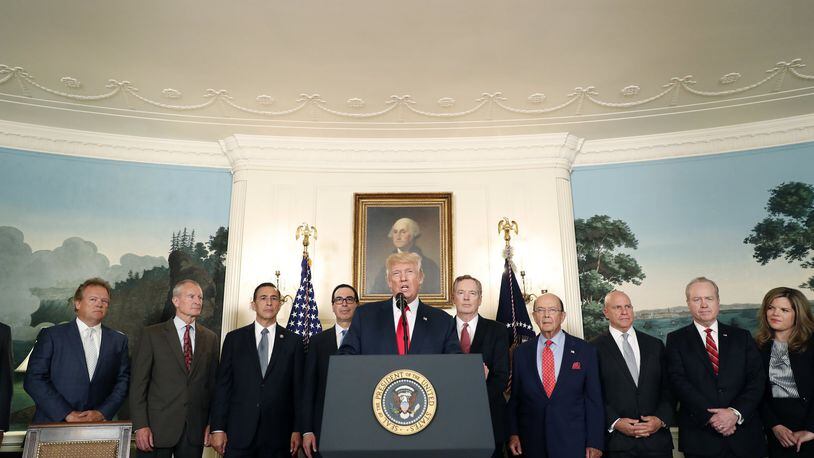 President Donald Trump speaks in the Diplomatic Reception Room of the White House in Washington, Monday, Aug. 14, 2017, during an event to sign a memorandum calling for a trade investigation of China. From left are, Marty Davis, The Cambria Company, Dennis Blair , Rep. Darrell Issa, R-Calif., Treasury Secretary Steven Mnuchin, the president, U.S. Trade Representative Robert Lighthizer, Commerce Secretary Wilbur Ross, National Security Adviser H.R. McMaster, and Tom Kennedy, Raytheon. (AP Photo/Alex Brandon)