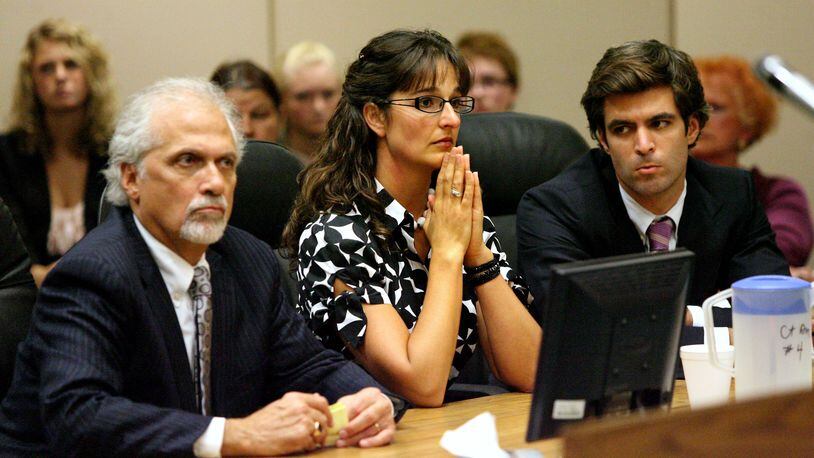 Stacy Schuler sits between her lawyers Charlie Rittgers (left) and Charlie M. Rittgers during her fourth day of trial in Warren County Common Pleas Court Thursday, Oct. 27, 2011. Schuler, 33, was sentenced to four years in prison after being found guilty on all 16 felony counts of sexual battery and three misdemeanor counts of providing alcohol to minors.