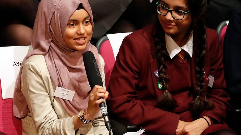 LONDON, ENGLAND - OCTOBER 11: Ayesha Begum, 17, (L) asks a question to the First Lady of the United States Michelle Obama, via a video link at the Mulberry School for Girls on October 11, 2016 in London, England. A Global Conversation on Girl's Education was a digital conversation with adolescent girls around the world. The event took place in celebration of International Day of the Girl. Girls in Washington, D.C., Jordan, Peru, Tanzania, and the Mulberry School for Girls in the United Kingdom spoke with one another about the challenges they have faced and potentially overcome in attaining an education. (Kirsty Wigglesworth-WPA Pool/Getty Images)