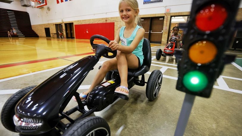 Kiya Laudick, 5, drives a pedal car during Lakota Safety Village.  Lakota schools, West Chester Police Department, Butler County Sheriff's Office and other have partnered for Lakota Safety Village to teach young children going into kindergarten school etiquette, bus and car safety, fire safety and more at Lakota Freshman School in West Chester Township. NICK GRAHAM/STAFF