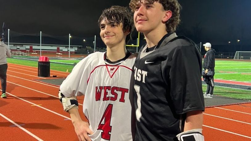 Lakota East's AJ Harrison and Lakota West's Reice Hafl, who are cousins, pose for a picture after their lacrosse match on Tuesday. CONTRIBUTED