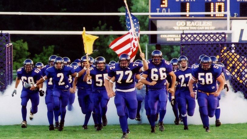 The 2001 Bellbrook High School football team, led by Charlie O'Dell (with flag), PHOTO by Nick Falzarano, Nicholas Studios
