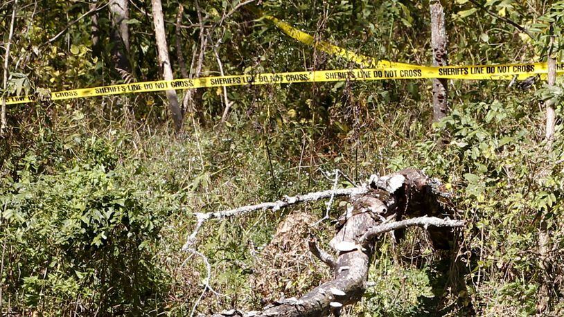 Warren County Sheriff’s security tape is strung through a heavily wooded area along the Little Miami River where a small airplane crash claimed the lives of a pilot and passenger on Sunday, October 17, 2016. The crash scene is located about one-half mile south of State Route 350 where it crosses the scenic river. TY GREENLEES / STAFF