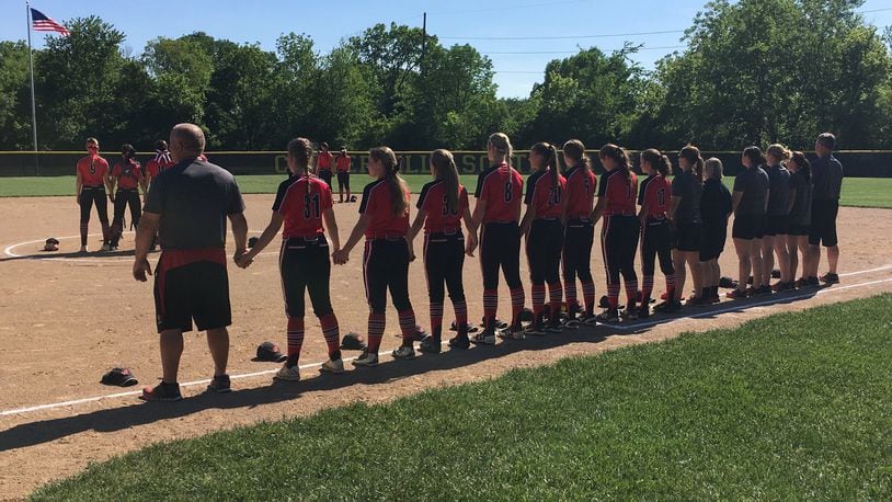 Lakota West’s players and coaches stand together during the National Anthem at last Wednesday’s Division I regional semifinal against Mason at Centerville. RICK CASSANO/STAFF