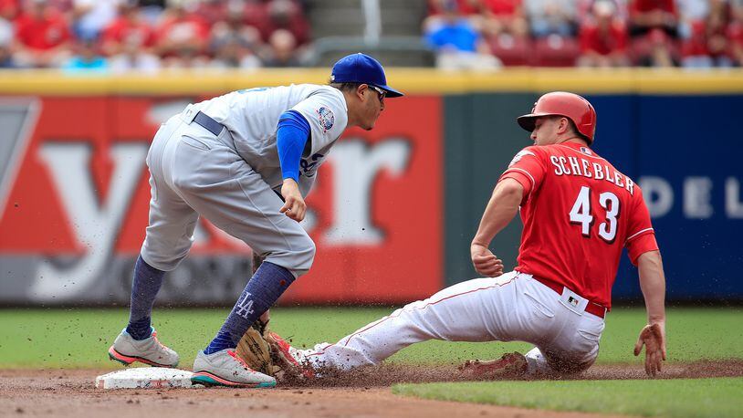 CINCINNATI, OH - SEPTEMBER 12: Manny Machado #8 of the Los Angeles Dodgers tags out Scott Schebler #43 of the Cincinnati Reds as he attempted to steal second base in the first inning at Great American Ball Park on September 12, 2018 in Cincinnati, Ohio.  (Photo by Andy Lyons/Getty Images)