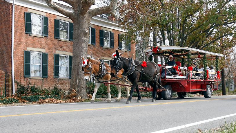 A horse drawn trolley makes its way through Shandon, Ohio as part of the village's 32nd annual Old Fashioned Christmas in the Country celebration Saturday Nov. 29, 2008.