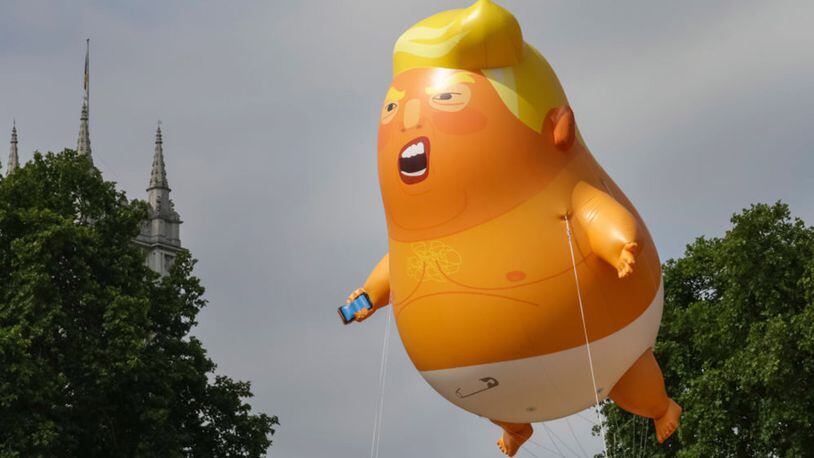 A giant baby trump balloon flies over the Parliament Square during a demonstration against the visit to the UK by US President Donald Trump on July 13, 2018 in London, England.