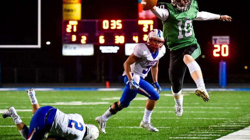 Badin quarterback Zach Switzer jumps out of bounds for a first down during their homecoming football game against Carroll Friday, Sept. 28 at Hamilton High School’s Virgil M. Schwarm Stadium. The Rams won 24-21. NICK GRAHAM/STAFF