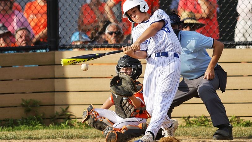 Hamilton's Maddox Jones makes contact with the ball during Hamilton West Side Little League's 10-1 win over Loveland in the District 9 Little League championship Monday, July 11, 2022 at Home of the Brave Park in Loveland. NICK GRAHAM/STAFF6