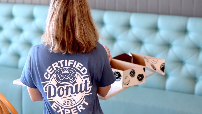 The Butler County Visitors Bureau recently unveiled the 2021 ‘Certified Donut Expert’ T-Shirt. CONTRIBUTED