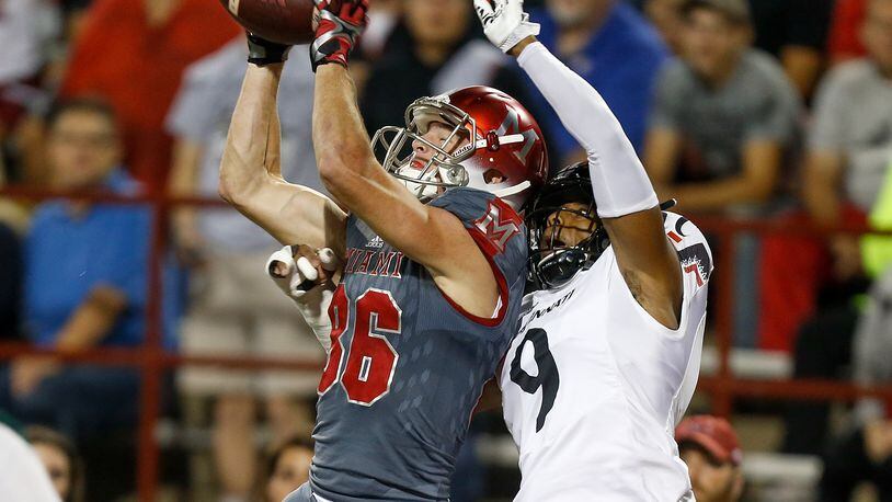 OXFORD, OH - SEPTEMBER 16: Luke Mayock #86 of the Miami Ohio Redhawks catches a touchdown defended by Linden Stephens #9 of the Cincinnati Bearcats during the first half at Yager Stadium on September 16, 2017 in Oxford, Ohio. (Photo by Michael Reaves/Getty Images)