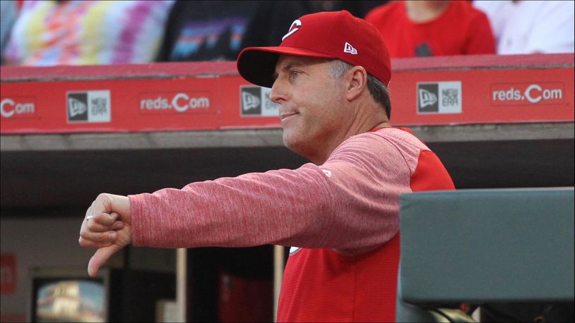Reds manager Bryan Price motions to the umpires that he won't call for a review of a play at first base against the Brewers on Tuesday, June 27, 2017, at Great American Ball Park in Cincinnati. David Jablonski/Staff
