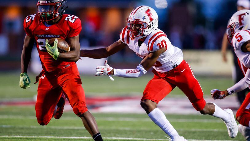 Lakota West's Cameron Goode (25) carries the ball trailed by Fairfield's Christian Jackson (10) during their football game Friday, Oct. 1, 2021 at Lakota West High School in West Chester Township. Lakota West won 42-10. NICK GRAHAM / STAFF
