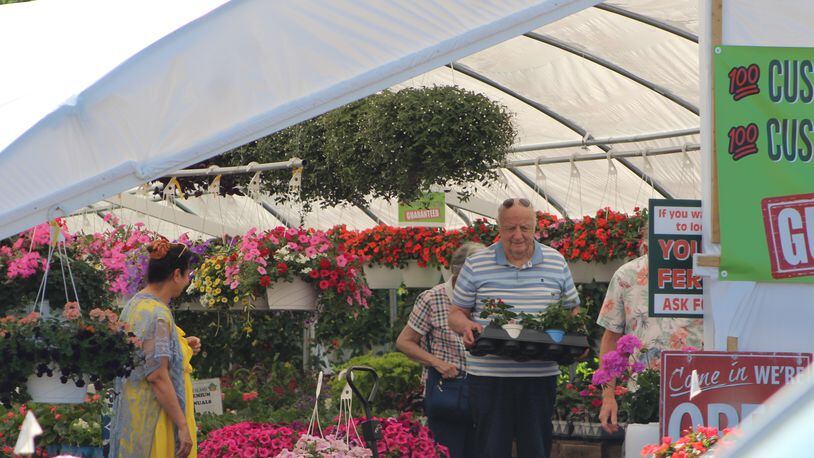 Customers buy flowers at the Gardenland in Centerville. CORNELIUS FROLIK / STAFF