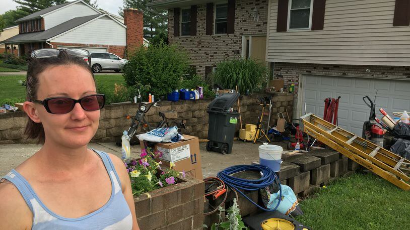 Alicia Johnson, who lives on Taylor School Road in Seven Mile, calls the items lost in Wednesday’s flooding “just stuff” but it’s painful losing memories that can’t be replaced. RICK McCRABB/STAFF