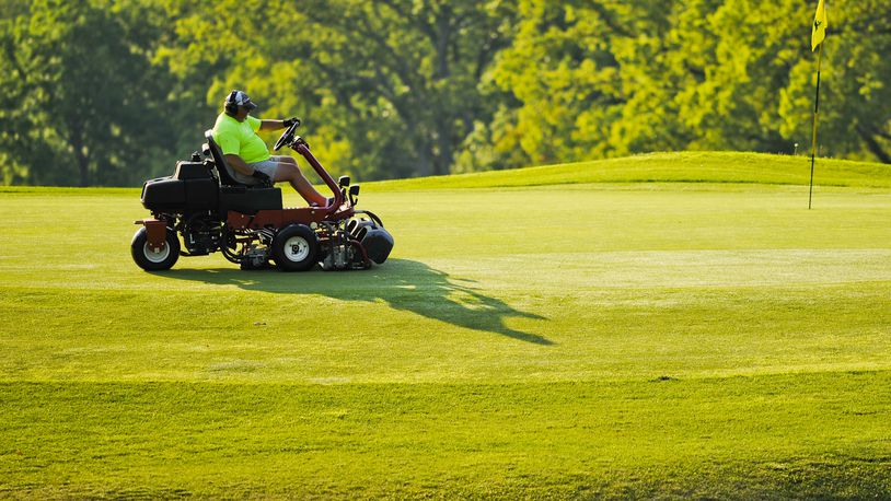 Hamilton bought specialized mower-blade sharpeners for about $10,000 from Middletown’s Weatherwax Golf Course after it closed last November. Pictured is an employee cutting the greens at Potter’s Park golf course in Hamilton. STAFF FILE PHOTO
