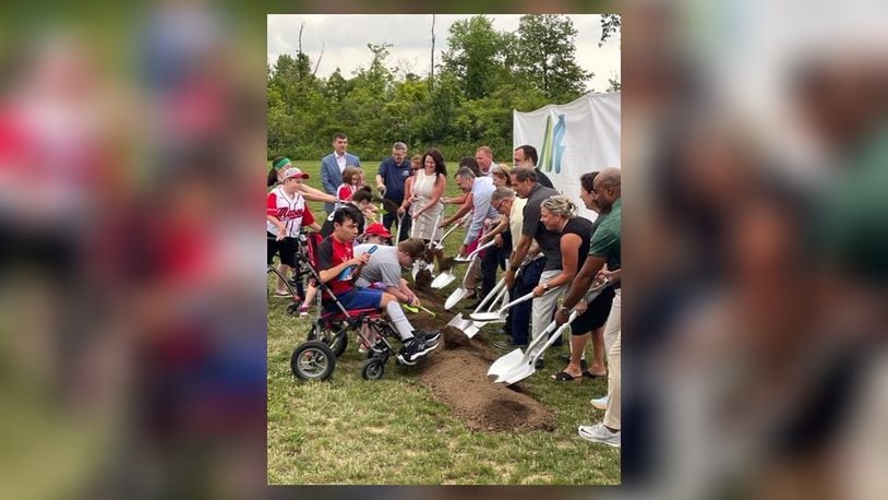Local, county and state representatives join players and others turn the first shovels of dirt at the Adaptive Ball Fields at Makino Park in Mason, which will open in spring 2024. CONTRIBUTED