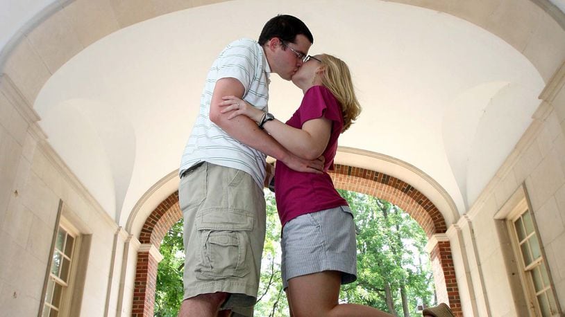 Stephanie Reid and Nick Hieber kiss under the Upham Arch in 2009. Legend states you will marry the person you kiss under the lantern inside the arch of Upham Hall at midnight. STAFF FILE PHOTO/2009