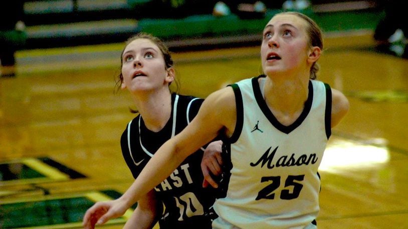 Mason's Becca Sanders (25) boxes out Lakota East's Addyson Johnson (10) on Saturday afternoon at Mason Middle School. Chris Vogt/CONTRIBUTED