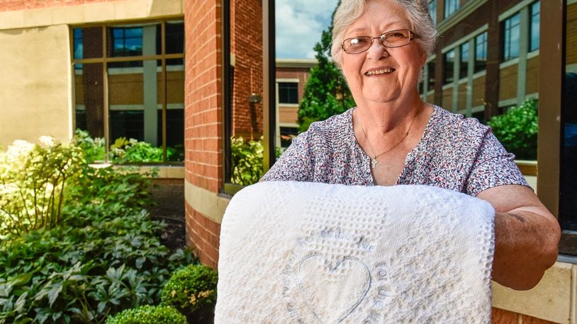 Atrium Medical Center wanted to create something for families to be able to take with them as a reminder of the generous act of their loved one to save others’ lives in their death by donating organs. Kathy Farler, with Thread Bear Designs, a volunteer with Atrium Medical Center has created a blanket that will be given to each of these families. Farler, who has operated her Middletown business for more than 20 years, embroiders these words on each blanket: “Remember me for the life I give for the life I’ve lived.” NICK GRAHAM/STAFF