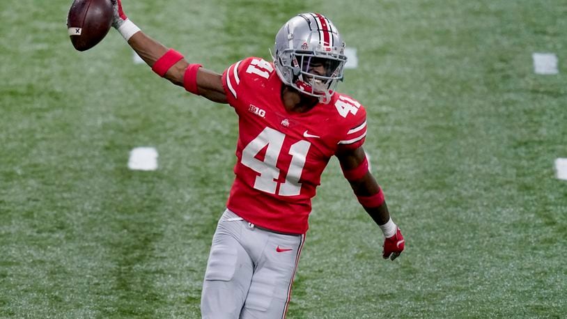 Ohio State safety Josh Proctor celebrates after intercepting a pass during the second half of the Big Ten championship NCAA college football game against Northwestern, Saturday, Dec. 19, 2020, in Indianapolis. (AP Photo/Darron Cummings)