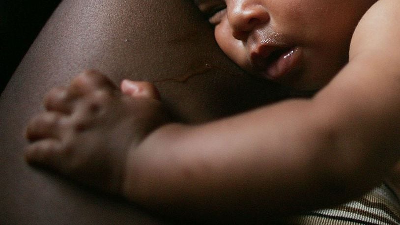 Baby in mother's arms. (Photo by Mario Tama/Getty Images)