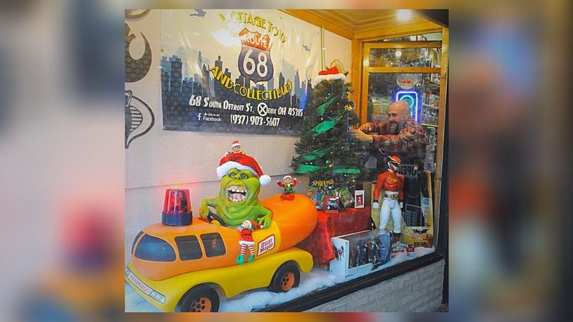 Rob Eldridge works on the display window at his business Route 68 Vintage Toys and Collectibles during the Xenia s Hometown Christmas Saturday Nov. 23, 2019.