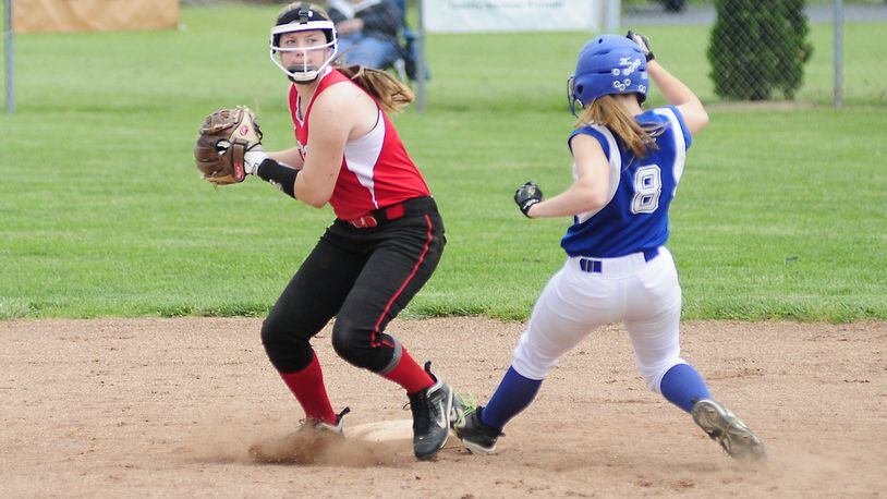 Madison’s Natalie Higgins (5) gets the out on Miami East’s Kris Bigelow (8) and throws to first base during a Division III district final May 25, 2013, at Tippecanoe Middle School. COX MEDIA FILE PHOTO