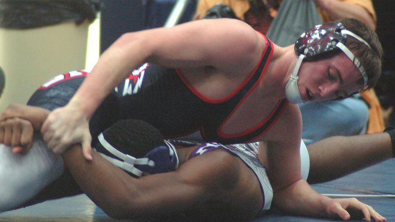 Fairfield’s Andrew Sams (top) tries to break the grip of Elder’s Charles Sanders during their 170-pound title match in the Division I district tournament at Fairmont’s Trent Arena on Saturday. Sams claimed a 15-5 win and his third title. CONTRIBUTED PHOTO BY JOHN CUMMINGS