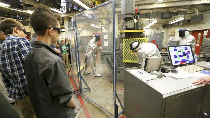 Students from Middletown and Monroe high schools listen to AK Steel research engineer Grant Thomas after viewing a hot rolling process demonstration as part of Manufacturing Day in 2015. GREG LYNCH / STAFF