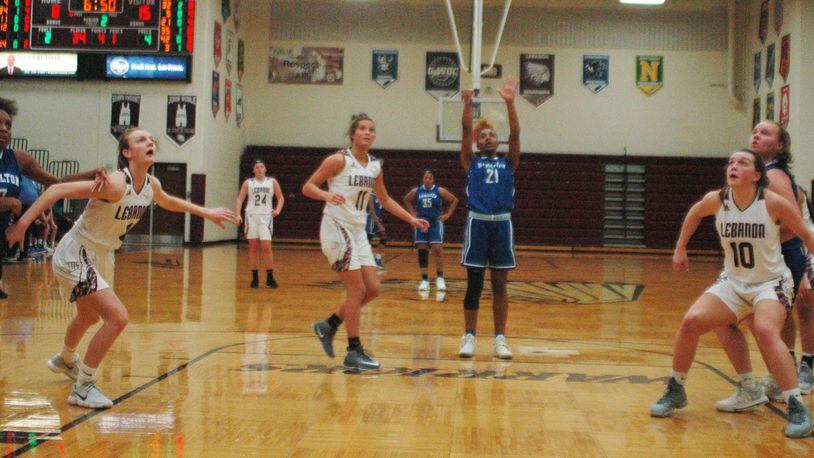 Hamilton’s CiCi Riggins shoots a free throw as Lebanon’s Molly Lane (4), Ashley West (11) and Isabella Dunn (10) do some boxing out Monday night at Lebanon. Visiting Big Blue won 52-42. RICK CASSANO/STAFF