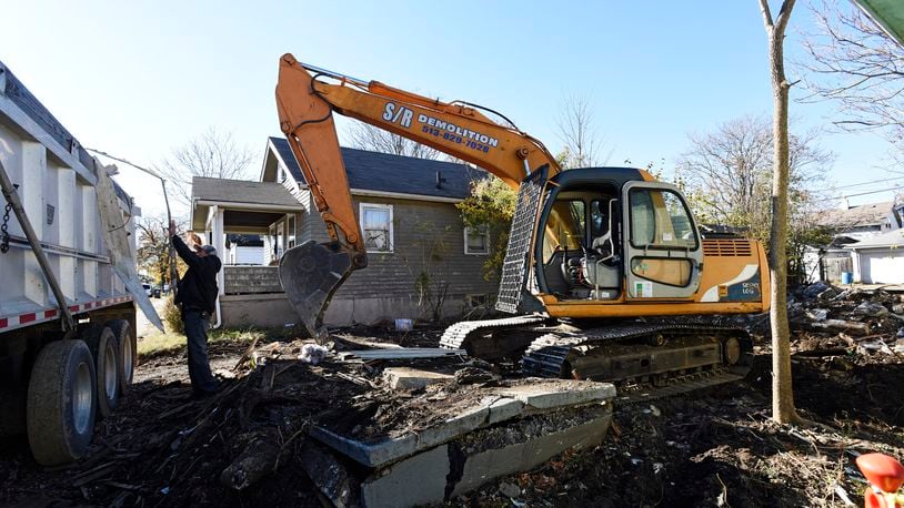 In this 2016 file photo, S/R Demolition demolishes a house in Hamilton. Funds for the demolition were received through the Butler County Land Bank. FILE