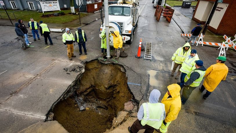 Middletown residents will see a 15 percent increase in sewer rates in 2018. City officials said part of the reason for the steep increases are due to the condition of Middletown’s sewer system. Pictured are crews repairing a water main break and sewer pipe collapse that caused a large sinkhole along Crawford Street in February. NICK GRAHAM/STAFF