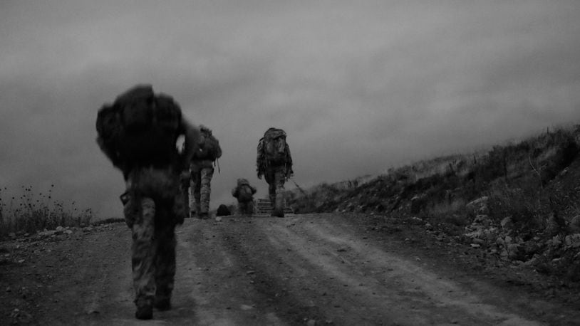 U.S. Army Green Berets conduct an early morning ruck march during a team-building event. A woman has completed the Special Forces Assessment and Selection for the first time.
