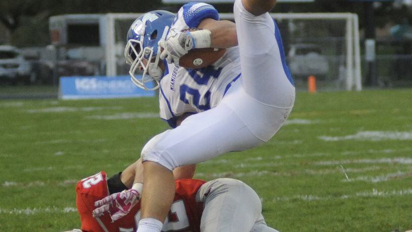 Miamisburg’s Tony Clark (top) is upended by Troy’s Jacob Anderson. Miamisburg defeated Troy 21-17 in a Week 5 high school football GWOC crossover game. Troy is No. 2 in Division II, Region 8 and Miamisburg is No. 4 in D-II, Region 8. MARC PENDLETON / STAFF