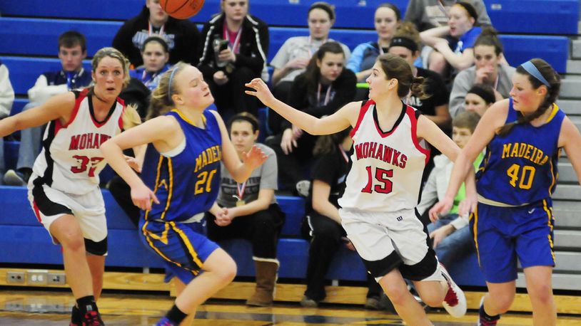 Madison’s Josey Harding (32) and Michelle Brunswick (15) make a turn over Madeira’s Mallory Kline (20) during a Division III tournament game in Springfield on March 2, 2013. JOURNAL-NEWS FILE PHOTO