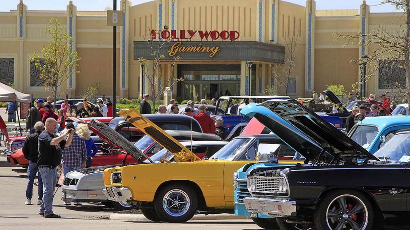 Spectators take pictures of the cars at the cruise-in at Hollywood Gaming at Dayton Raceway in a previous year. This year’s show will be April 28. © Photo by Skip Peterson