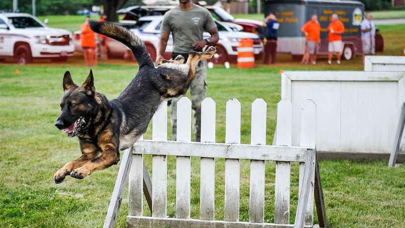 Chase, a Middletown canine officer, has retired and the department is adding three canine officers, giving the department five. Here, Chase, under the watchful eye of his partner Ryan Morgan, jumps a hurdle during National Night Out at Berachah Church. A similar demonstration is planned for this year’s event.