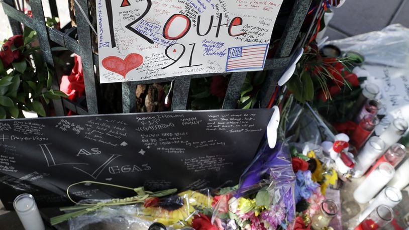 Flowers and signs are left at a memorial for the victims of a mass shooting in Las Vegas, Wednesday, Oct. 4, 2017, in Las Vegas. A gunman opened fire on an outdoor music concert on Sunday killing dozens and injuring hundreds. (AP Photo/Marcio Jose Sanchez)