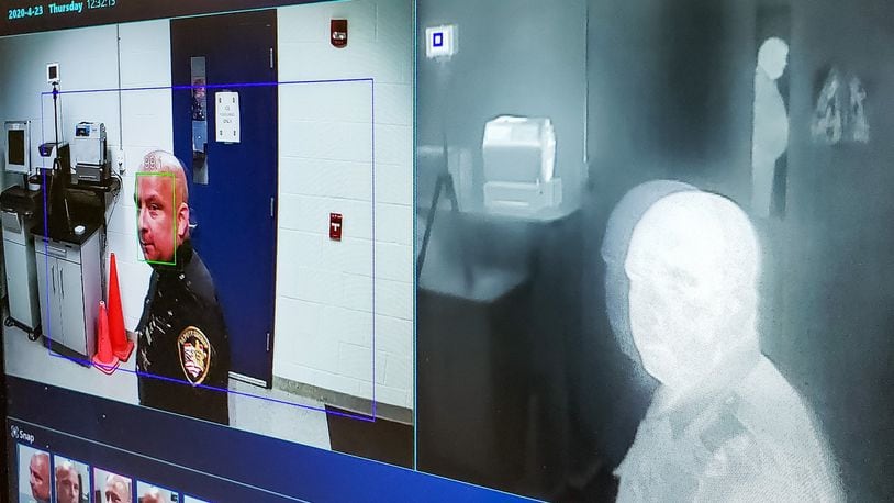 Butler County Sheriff’s deputy Ed Asher demonstrates a new thermal imaging camera in the booking area of the Butler County Jail Thursday, April 23, 2020 in Hamilton. The camera is capable of scanning temperature and taking a photo of people entering the jail. NICK GRAHAM / STAFF