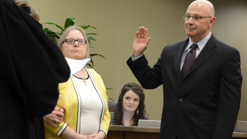 Fairfield City Council member Mark Scharringhausen takes his oath of office on Monday, March 9, 2020. He was appointed to fill the remaining term of the late Council member Ron D’Epifanio, who died on Jan. 21 with two years remaining on his term. Also pictured is Fairfield Municipal Judge Joyce Campbell (administering the oath) with D’Epifanio’s daughter, Lynne. MICHAEL D. PITMAN/STAFF